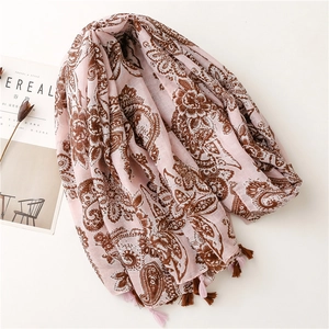 Pink bohemian paisley cotton scarf with tassels displayed with a Cereal magazine