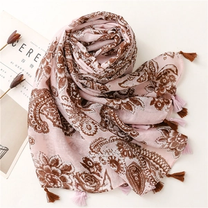 Detail of pink bohemian paisley scarf with tassel edges and vintage floral print