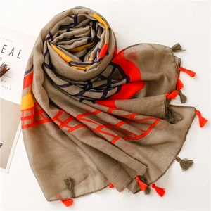 Dark brown scarf with geometric map pattern and colorful tassels on white background