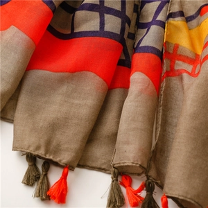 Detailed close-up of dark map pattern scarf showing linen texture and fringe tassels