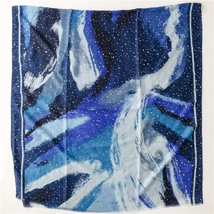 Detail of blue ink painting scarf with gold foil dots and soft fringe edges