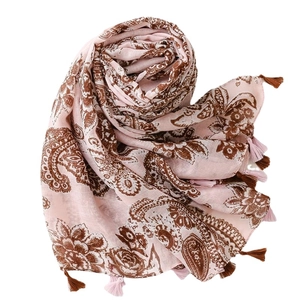 Pink bohemian scarf with brown paisley floral prints and tassels on a white backdrop