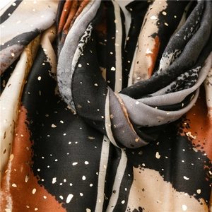 Close-up of soft cotton linen scarf with metallic gold foil dots and ink painting print