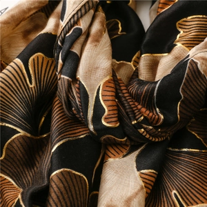 Detailed view of luxury ginkgo leaf pattern with gold foil on soft cotton linen scarf