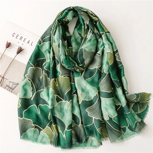 Green cotton-linen scarf with gold ginkgo leaf pattern and soft tassel edges