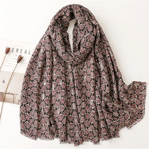Red and black leaf pattern cotton linen scarf with frayed edges on white background
