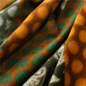 Detailed macro view of soft multicolor polka dot cashmere-feel fabric with neat stitching