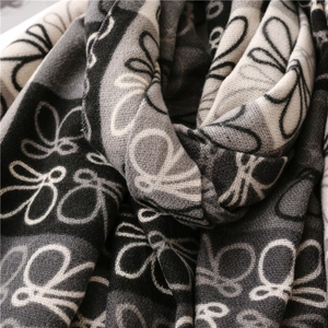 Close-up of soft thick cashmere scarf with vintage dragonfly pattern texture detail