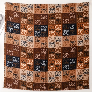 Detailed view of checkered cashmere-feel scarf with spiral patterns and frayed edges