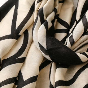 Macro shot showing soft cotton-linen fabric texture with geometric line patterns