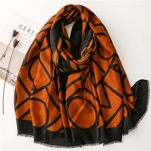 Orange and black cotton-linen scarf with geometric patterns and fringe detail