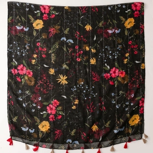 Detail of vintage ethnic scarf with floral print, sequins and handmade tassels