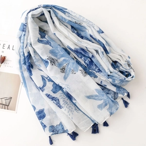 Blue tropical leaf and butterfly print scarf with tassels on white minimalist background
