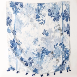 Detail of blue ink floral print on white scarf with matching blue tassel fringe edges
