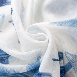 Detail of blue and white floral pattern on soft cotton-linen feel scarf fabric