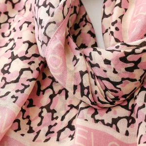 Detailed view of soft cotton-linen scarf featuring pink and black leopard letter pattern