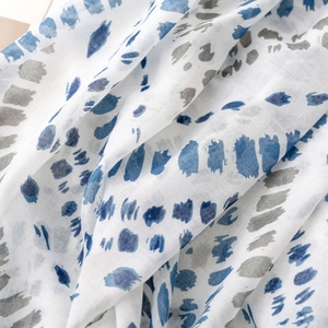Detailaufnahme des weichen Schals mit blauen und grauen abstrakten Punktmustern