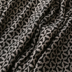 Close-up of black cotton-linen feel scarf with interlocking circle print and soft texture