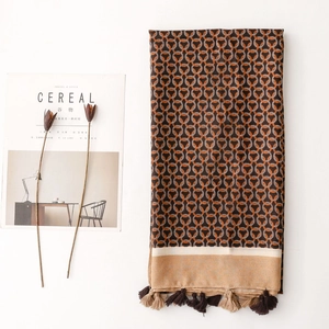 Detail view of winter shawl with interlocking ring patterns and fringe tassels