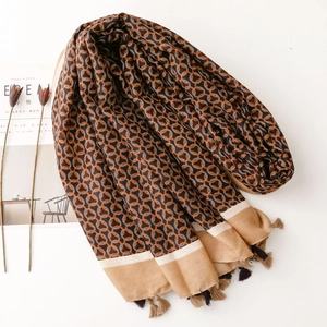 Detailed view of ring pattern and textured tassels on retro brown patterned shawl