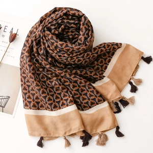Detail of herringbone pattern texture with chain ring print and tassels on a winter shawl
