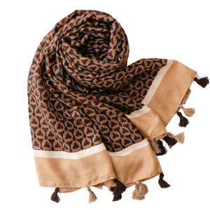 Winter warm scarf with geometric circular pattern and tassel trim in orange and brown
