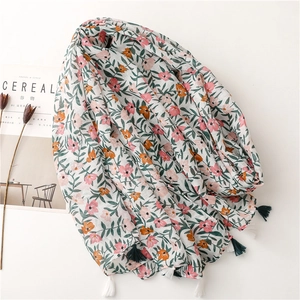 Floral cotton linen scarf with tropical print and fringe tassels in soft summer colors