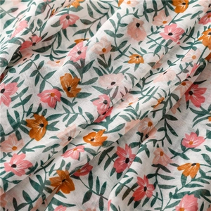 Detailed macro view of tropical floral print on breathable cotton linen scarf fabric