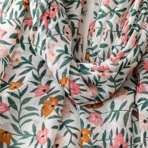 Close-up of tropical floral print on lightweight linen-feel scarf with delicate textures
