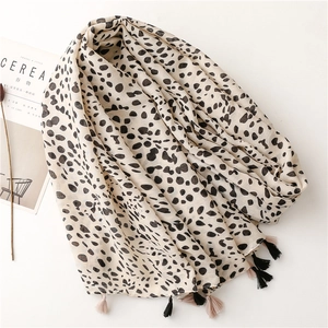 Elegant leopard print scarf with fringe tassels on white background with magazine