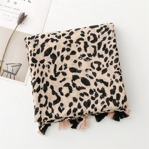 Detail of leopard print scarf with soft texture and stylish black and pink tassels