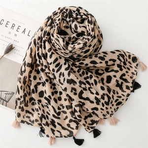 Close-up of khaki leopard print scarf featuring stylish fringe edges and soft texture