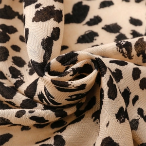 Macro detail of soft leopard print fabric texture on a winter thick shawl scarf