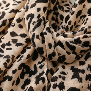 Macro shot of soft leopard print scarf fabric showing detailed weaving and texture