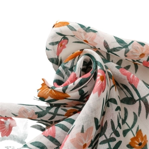 Lightweight floral cotton linen scarf featuring a tropical print and fringed edges