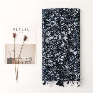 Vintage navy blue floral scarf with elegant tassels displayed on a clean white background