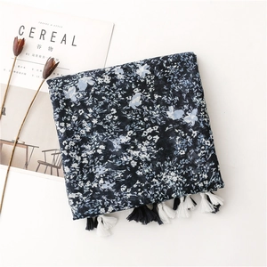 Navy floral shawl with cotton tassels shown in an elegant flat lay artistic composition