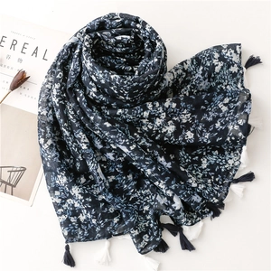 Vintage navy blue floral scarf with white petal patterns and elegant tassel edge decor