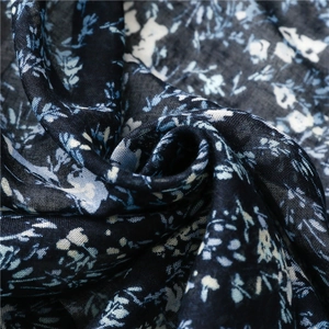 Close-up of navy floral scarf showing fine texture and soft fabric drapes