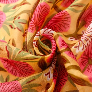 Macro detail of breathable cotton linen scarf featuring hand-painted floral textures