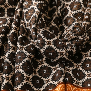 Detail of warm winter scarf showing intricate copper grass pattern and soft cotton texture