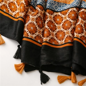 Close-up of bohemian mandala print scarf with intricate patterns and fringe tassels