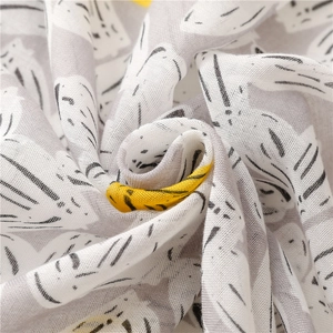Close-up detail of soft breathable cotton fabric with cute cartoon cat print pattern