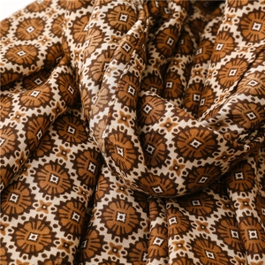 Detailed view of bohemian style circular pattern and woven texture on warm shawl fabric