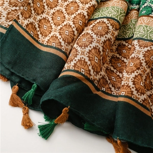 Detail of vintage floral print scarf with ethnic patterns and fringed tassel edges