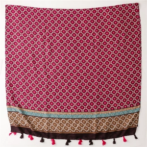 Detail of red bohemian scarf with mandala geometric prints and fringe tassels