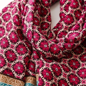 Detailed close-up of bohemian floral print scarf with soft woven fabric texture