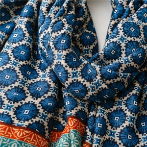 Macro shot of ethnic floral pattern and textured weave on warm winter shawl scarf