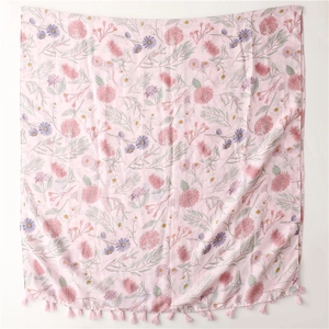 Detail of pink floral print scarf featuring soft cotton-linen fabric and tassel edges