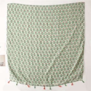 Close-up of lightweight floral cotton linen scarf with tassels in mint green color